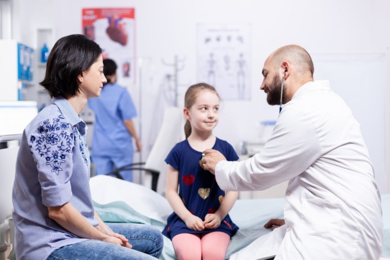 Pediatrician checking health